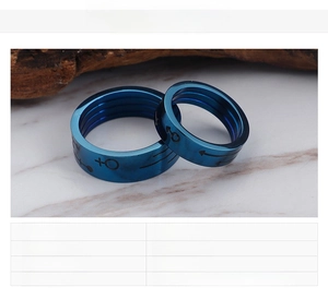 Detail view of blue stainless steel rings with male and female gender symbols