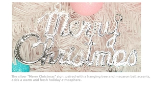 Close-up of silver Merry Christmas hanging sign on a pastel pink macaron tree
