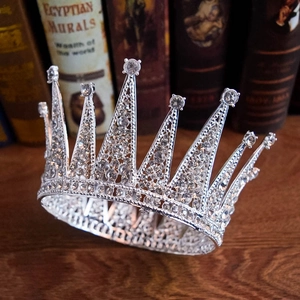 Detail of silver vintage bridal crown with sparkling crystals on a wooden surface