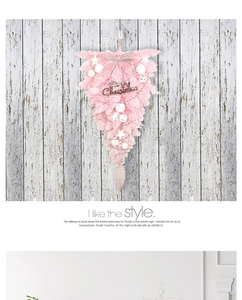Pink Christmas teardrop wreath with silver bow and Merry Christmas sign on wood