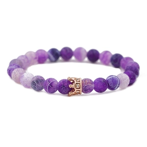 Purple turquoise beads bracelet with a rose gold crown charm on a clean white background