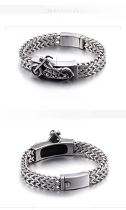 Macro detail of men's stainless steel biker bracelet with motorcycle relief and clasp