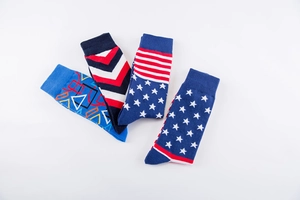 Macro detail of four pairs of cotton crew socks with US flag and geometric patterns