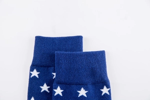 Macro shot of navy blue ribbed socks with white star patterns and premium cotton texture
