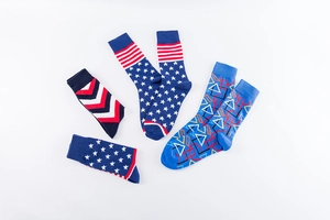 Detail of patterned cotton crew socks featuring star stripes and geometric knit designs