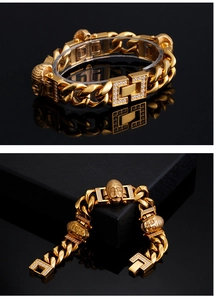 Close-up of gold Cuban chain bracelet with Buddha heads and white zircon pavé details