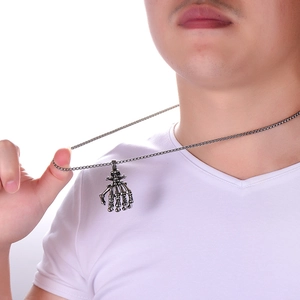 Gothic punk skeleton hand claw pendant necklace in vintage steel on male model
