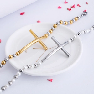 Cross beaded bracelet in gold and silver finish with pearls and floral decor