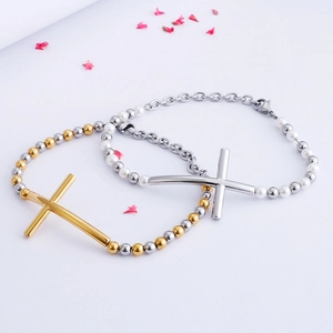Cross pendant bead bracelets in gold and silver steel with pearls on white background
