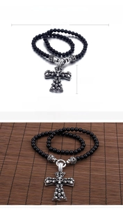Detail view showing dimensions of a punk skull cross necklace with black glass beads