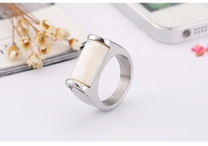 Close-up of minimalist titanium steel ring with white shell inlay and silver finish