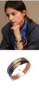 Detail of 19cm multi-layer leather bracelet with gold bars and snap closure for women