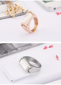 Detail of wide rose gold and silver rings with shell inlay and micro-pave crystals