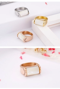 Detailed view of polished shell rings in gold, silver, and rose gold with pavé accents