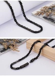 Detail of black stainless steel rectangular link chain with secure lobster clasp closure