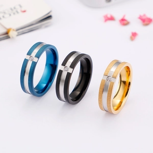 Brushed stainless steel rings in blue, black, and gold with a single zircon inlay