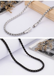 Detail view of silver clasp and black stainless steel dragon chain necklace for men