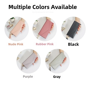 Detailed view of long leather wallets for women with heart pendant and tassel accents