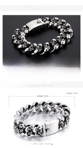 Macro shot of silver stainless steel skull links and flat buckle detail for men's bracelet
