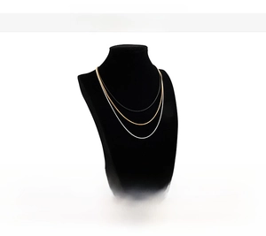 Detailed close-up of stainless steel round snake chains in gold, silver and black finishes