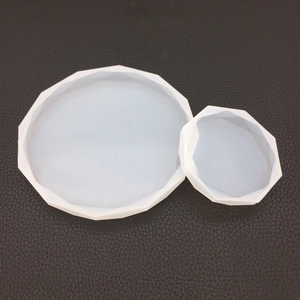 Detail showing two sizes of geometric diamond-cut silicone molds for resin casting