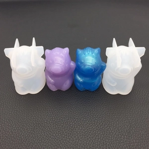 Detailed view of DIY 3D lucky pig silicone molds with finished resin craft examples