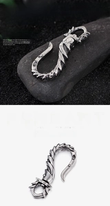 Detail of vintage silver feather keychain with dragon scale texture and rotating clip