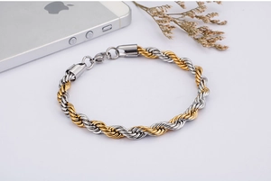 Detailed shot of a two-tone twisted rope chain necklace with lobster clasp