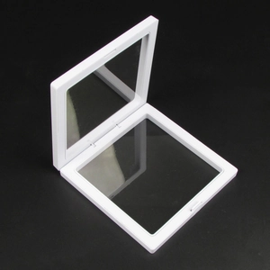 Detail view of square white PE film floating jewelry display box on black background