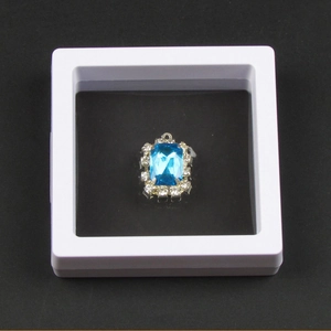 Blue rectangular crystal pendant displayed in white PE film 3D floating frame box