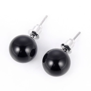 Detail of 10mm round black natural stone stud earrings with silver-plated needle and smooth finish