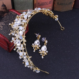 Detailed set of baroque gold crown and earrings with crystals on a vintage black background
