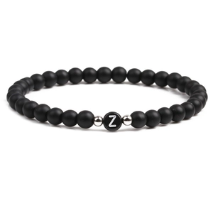 Detail of 6mm matte black stone beaded bracelet with silver bead and letter Z charm
