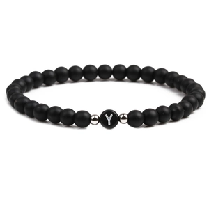 Detail of 6mm black matte stone beads bracelet featuring a letter Y charm and silver spacers