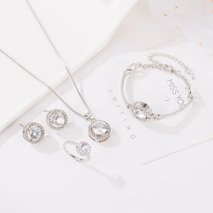 Sparkling silver jewelry set with round clear stones including necklace, bracelet and ring