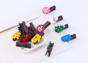 Detail of assorted Christmas wooden clips featuring snowman and reindeer patterns