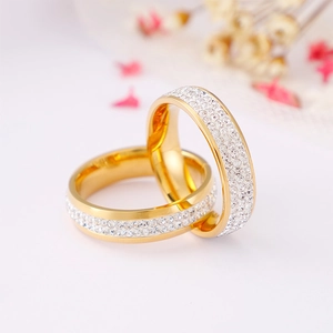 Elegant gold double band rings with sparkling white rhinestones on clean background