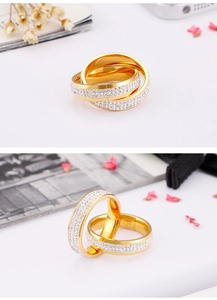 Detailed view of overlapping gold interlocking rings with sparkling white zircon pave setting