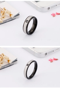 Detailed comparison of wide and narrow black brushed titanium rings with center zircon stone