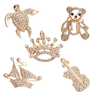 Detailed collection of gold plated rhinestone brooches in turtle and violin shapes