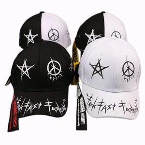 Detail view of graffiti star print baseball caps featuring elongated warning straps