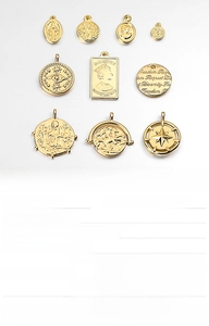 Macro view of vintage gold and silver coin charms for DIY jewelry making