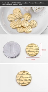Macro shot of 15mm gold coin charm with engraved inspirational words for DIY jewelry