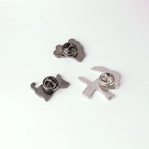 Detailed back view of creative cartoon metal lapel pins, displaying secure pin clutches.