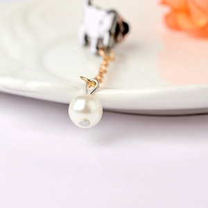 Detail of creative enamel cat brooch with white pearl pendant and delicate gold chain