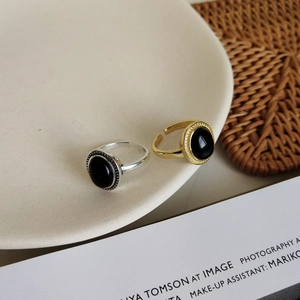 Detail of S925 sterling silver rings with oval black agate in gold and silver finish