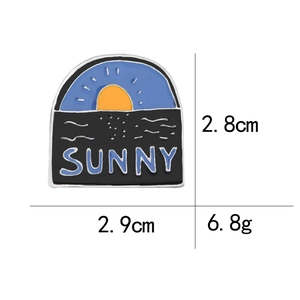 Detail view of Sunset SUNNY enamel pin showing 2.8cm x 2.9cm size dimensions and weight