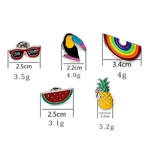 Cute enamel pins set with toucan, rainbow, and fruit designs for clothes and bags