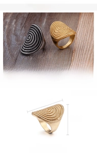 Detail of dome rings with spiral texture in steel and 18K gold plated stainless steel