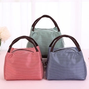 Three lunch bags in green, red, and blue with horizontal stripes and brown handles